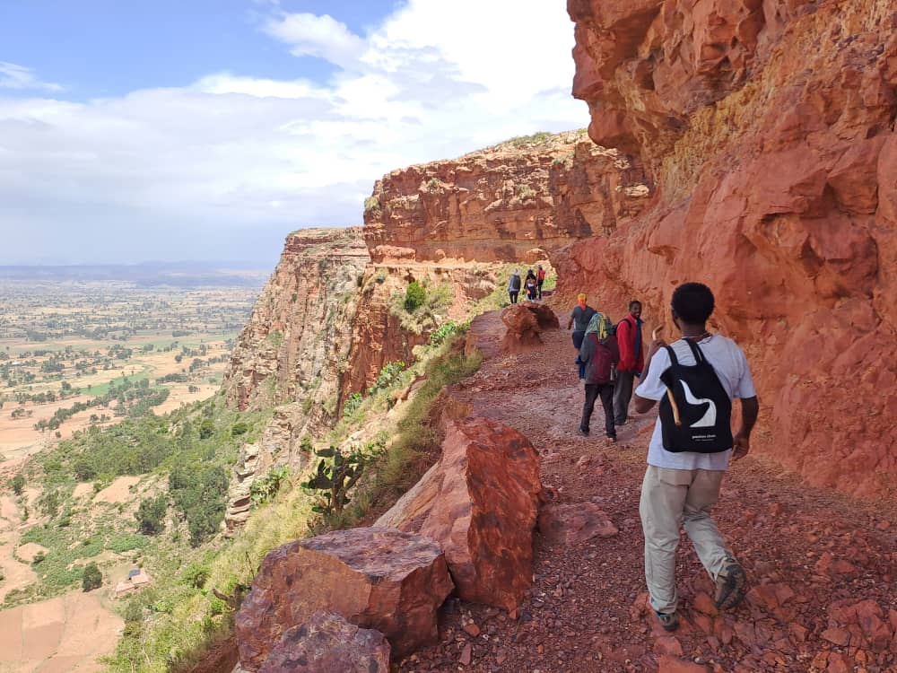 Hiking with view along the escarpments of the Agame Mountains